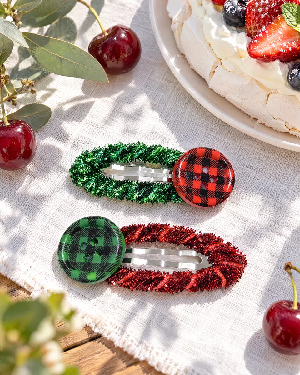 The clips on white linen beside a pavlova and fresh cherries